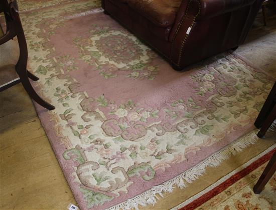 Pink ground Indian rug and a smaller rug(-)
